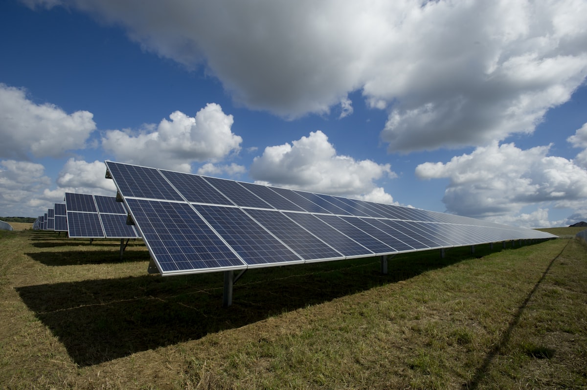 Aerial view of solar panels on green field