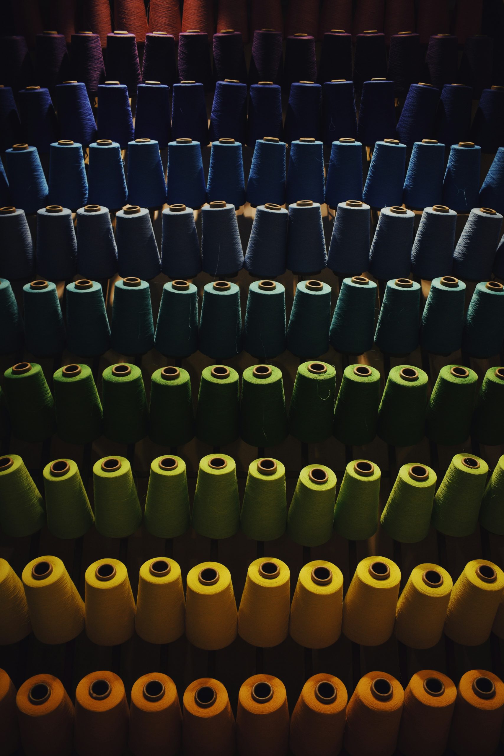 Textile manufacturing machinery and fabric rolls in a factory production line